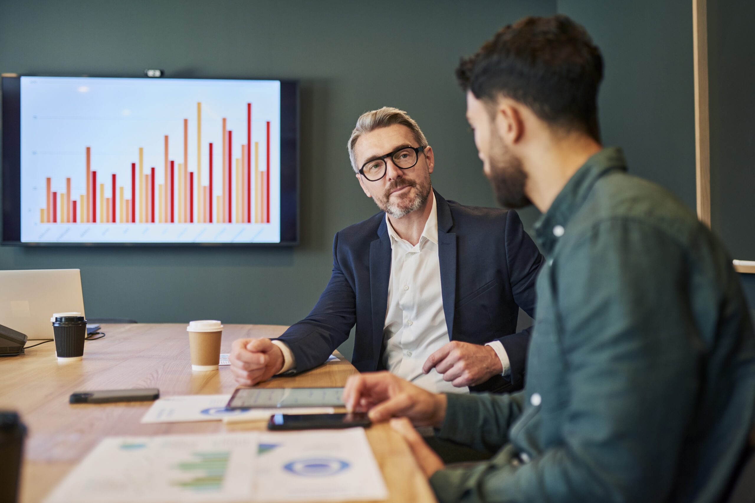 Business people sat talking in a meeting room